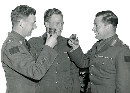 Maj-Gen. B.M. Hoffmeister celebrates victory on VE-Day with two of his senior officers, Lt-Col. C.H. Drury and Lt-Col. W.C. Dick. [Legion Magazine Archives]