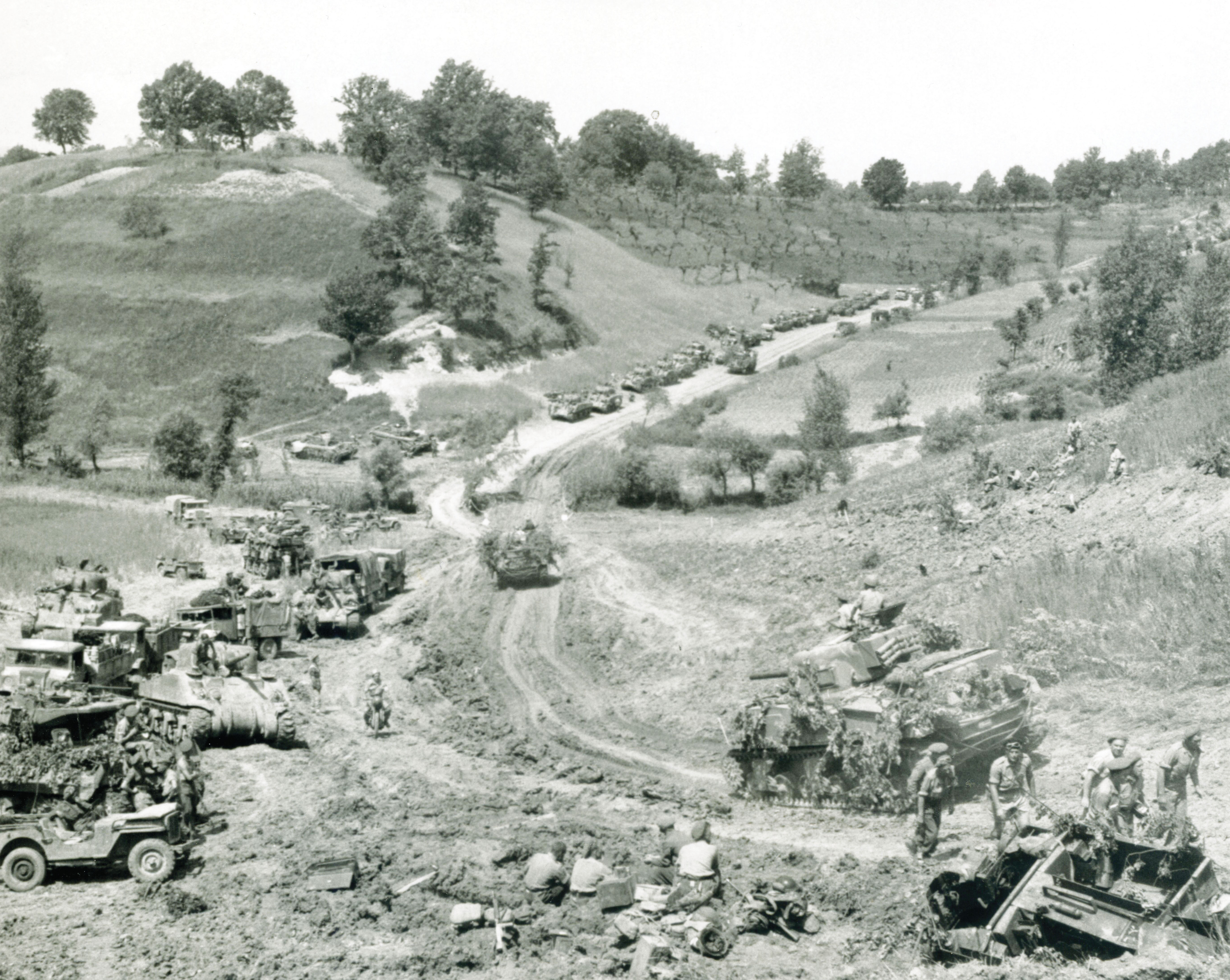 Canadian forces advancing from the Gustav Line to the Hitler Line – carrier in the foreground coming up steep hill with tanks in background – Sherman in foreground is hung up on the edge. 24 May 1944, Liri Valley, Italy