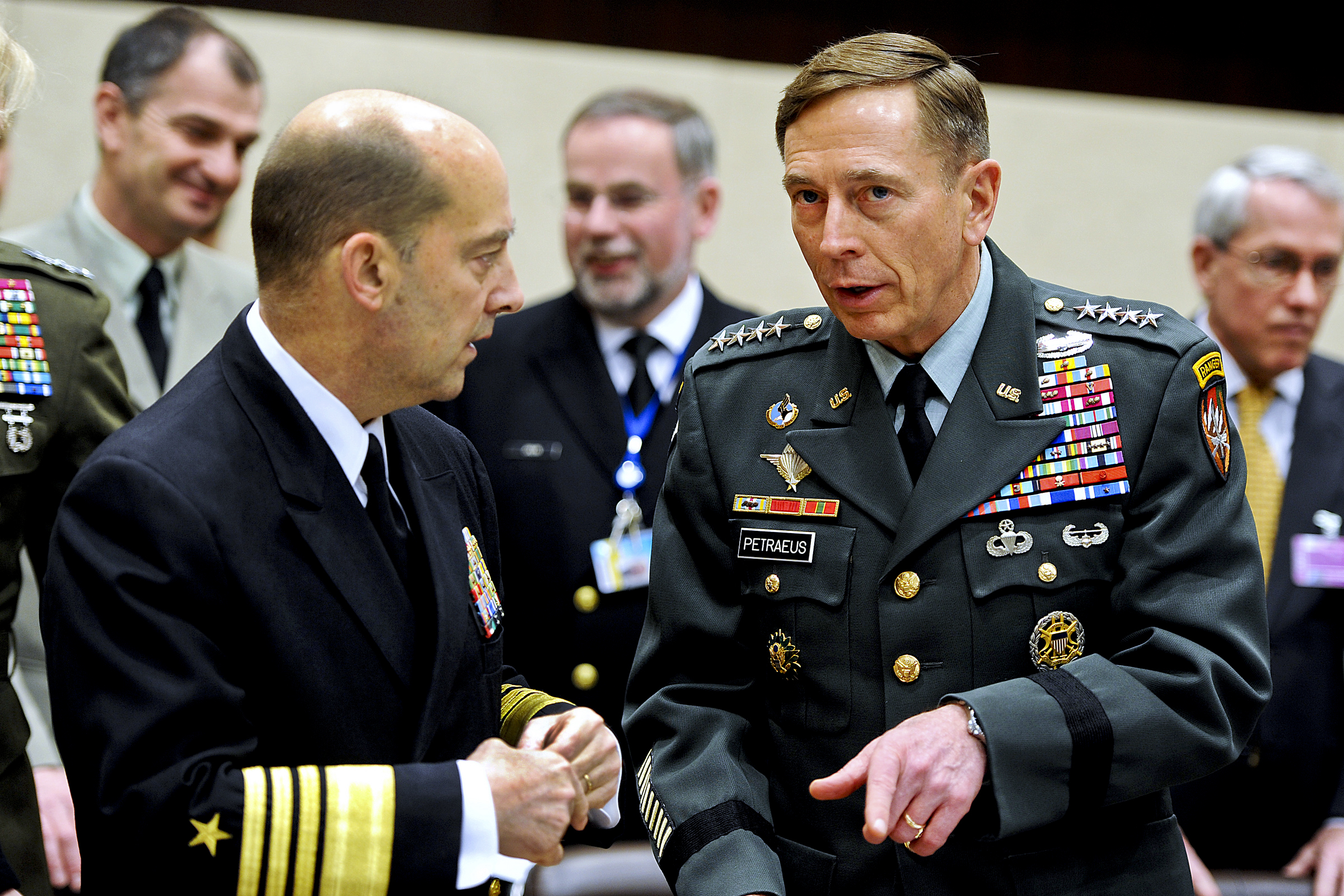 U.S. Army Gen. David H. Petraeus, right, Commander NATO International Security Assistance Force (ISAF) and U.S. Forces Afghanistan, speaks with Admiral James G. Stavridis, commander of European Command and Supreme Allied Commander, Europe, at the NATO headquarters in Brussels, Belgium March 11, 2011. Defense Department photo by Cherie Cullen (released)