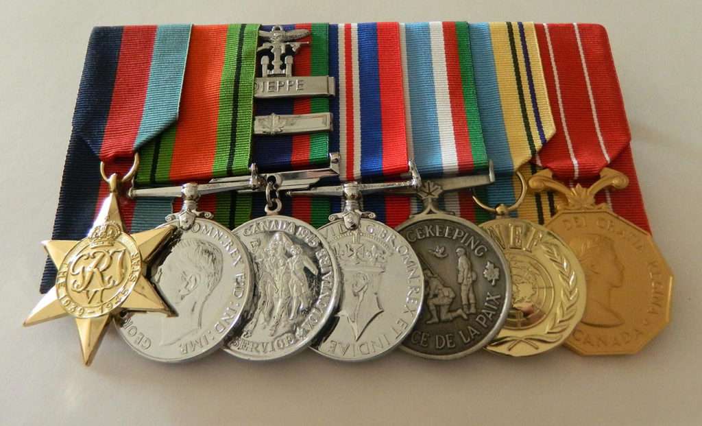 Raymond DeKelver's medals (from left): The 1939-1945 Star; The Defence Medal; The Canadian Volunteer Service Medals with Overseas Bar and Dieppe Bar; The 1939-1945 War Medal; The Canadian Peacekeeping Service Medal; The United Nations Emergency Force Medal; The Canadian Forces Decoration. DeKelver never saw the complete set.