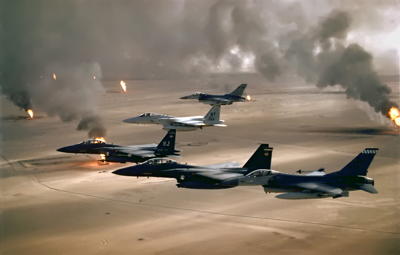 U.S. Air Force war planes flying over burning oil wells during Operation Desert Storm in 1991.