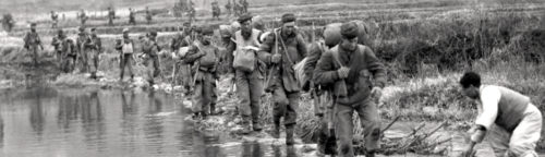 Patricias patrol a valley bottom in Korea in March 1951