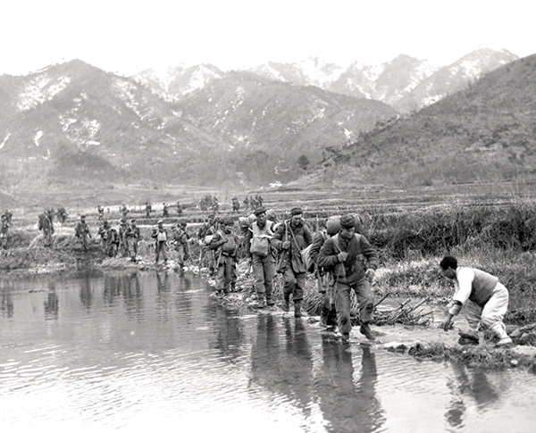 Patricias patrol a valley bottom in Korea in March 1951.