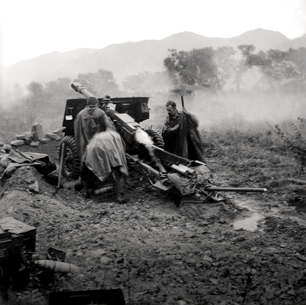 Fog and smoke surrounds a 25-pounder gun of the 2nd Field Regiment