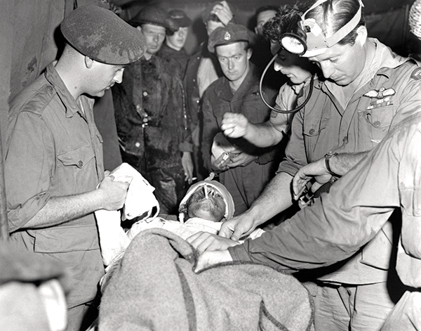 A severely wounded soldier gets first aid