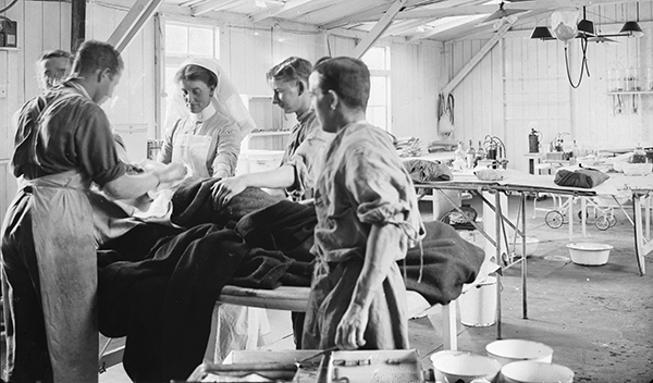 A surgeon, assistants and a nurse operate on a patient