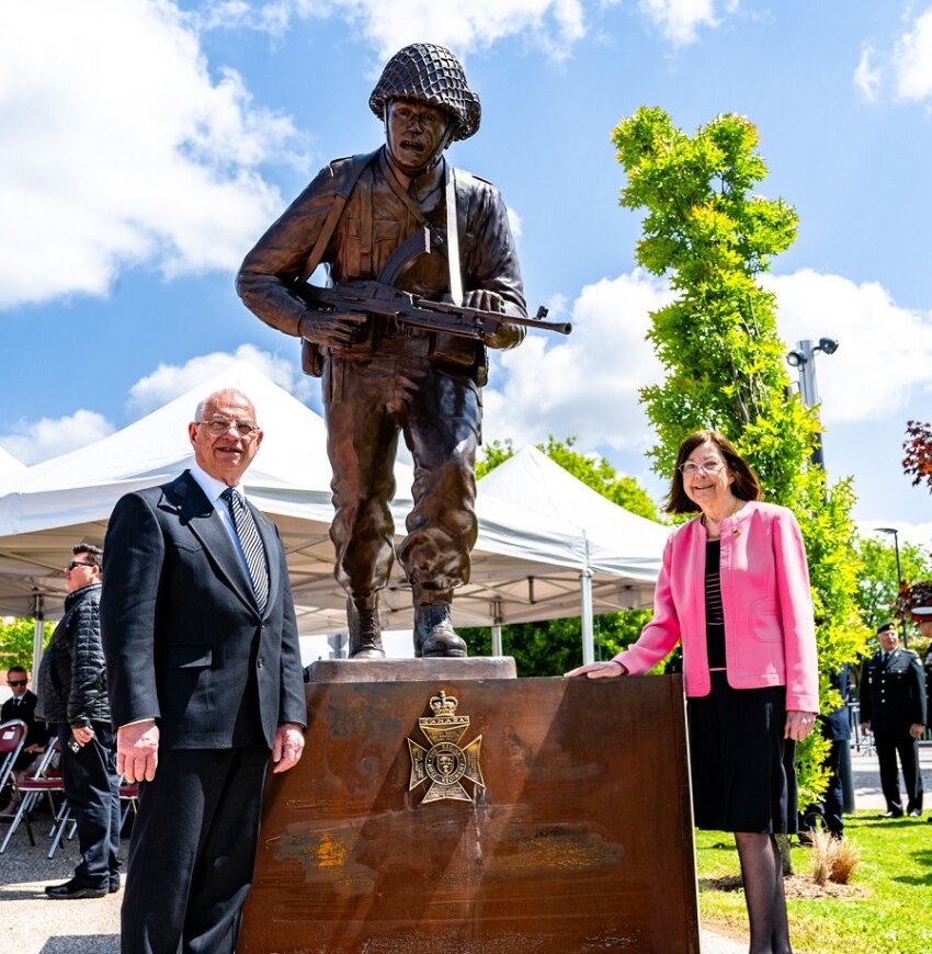 Don Begg and Shirley Stephens-Begg stand with the Royal Regina Rifles commemorative statue they sculpted during its unveiling at Thue et Mue, France, on June 5, 2024. [Corporal Antoine Brochu/Canadian Forces Combat Camera]