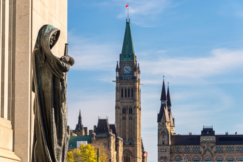 Walter Allward's Ivstitia (Justice) stands in front of the Supreme Court of Canada building. [Marc Bruxelle/istock]